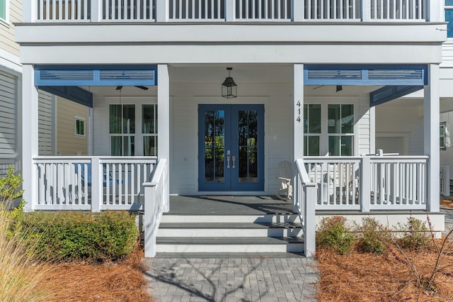 entrance to property with covered porch and french doors