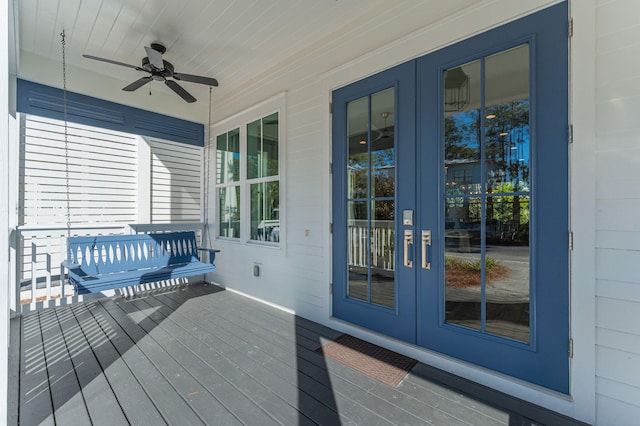 wooden deck with ceiling fan, french doors, and covered porch