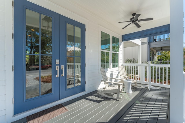 sunroom / solarium with ceiling fan and french doors