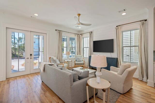 living room with ceiling fan, light hardwood / wood-style floors, plenty of natural light, and french doors