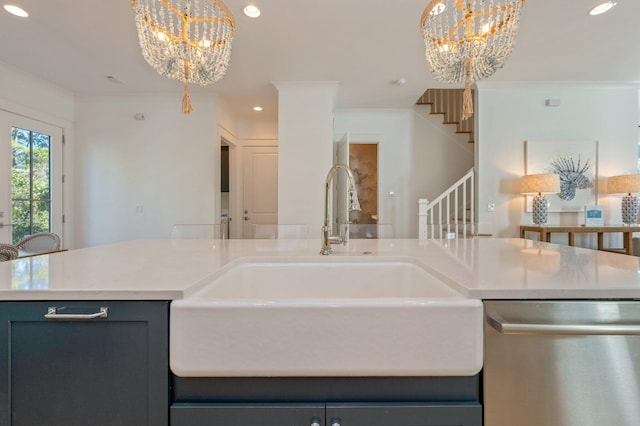 kitchen featuring a chandelier, pendant lighting, stainless steel dishwasher, and sink