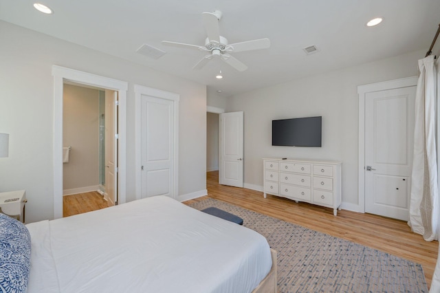 bedroom with connected bathroom, light hardwood / wood-style flooring, and ceiling fan