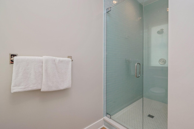 bathroom featuring a shower with shower door