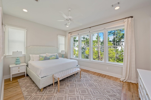 bedroom with ceiling fan and light hardwood / wood-style floors