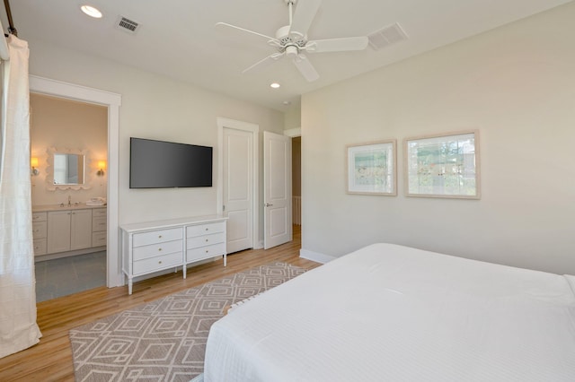 bedroom with ensuite bathroom, ceiling fan, and light hardwood / wood-style floors