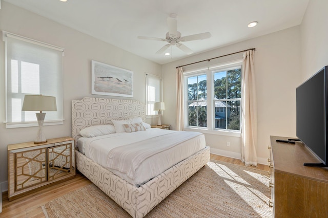 bedroom featuring ceiling fan and light hardwood / wood-style flooring