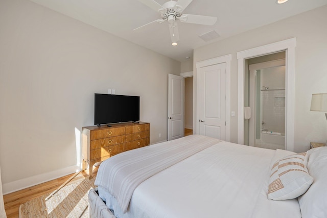 bedroom featuring ensuite bathroom, ceiling fan, and hardwood / wood-style flooring