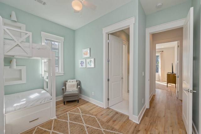 bedroom with ceiling fan and light hardwood / wood-style floors