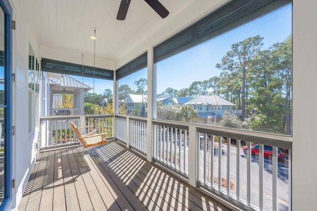 sunroom featuring ceiling fan and plenty of natural light