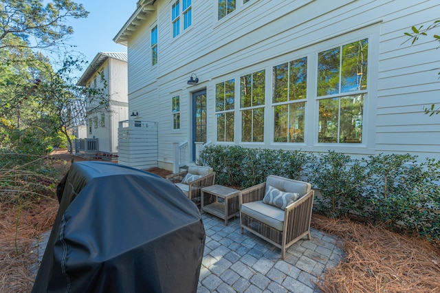 view of patio featuring area for grilling and cooling unit