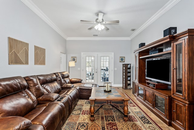 living room featuring crown molding, wood-type flooring, french doors, and ceiling fan