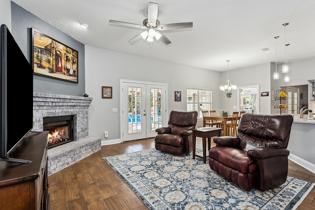 living room with sink, dark hardwood / wood-style floors, a fireplace, and french doors