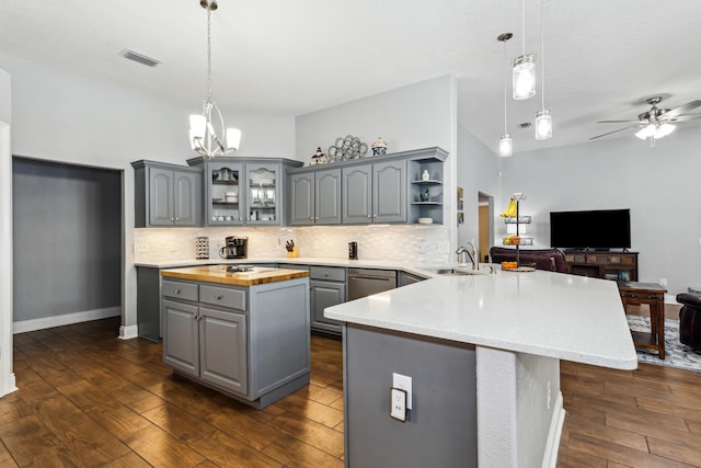 kitchen featuring gray cabinets, a center island, sink, and decorative light fixtures