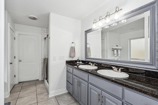 bathroom featuring an enclosed shower, vanity, and tile patterned floors