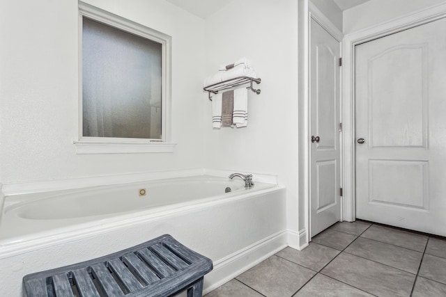 bathroom with tile patterned flooring and a tub to relax in