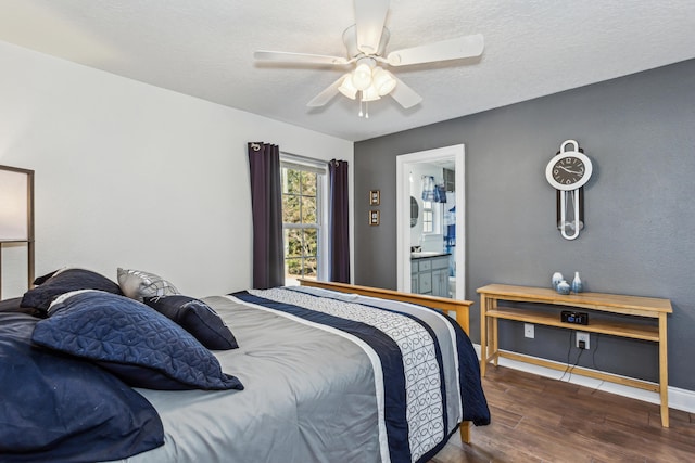 bedroom featuring ceiling fan, ensuite bathroom, and dark hardwood / wood-style flooring