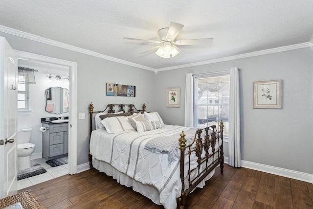 bedroom featuring ceiling fan, crown molding, and ensuite bath