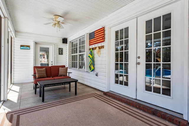 sunroom featuring french doors and ceiling fan