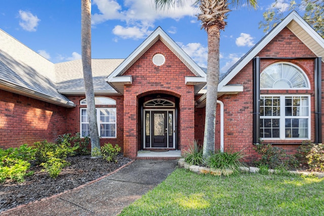 entrance to property featuring a yard