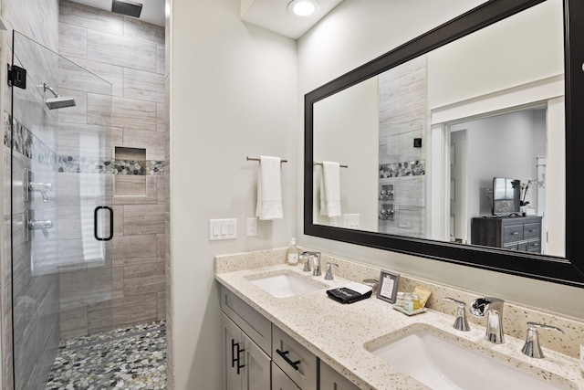 bathroom featuring vanity and an enclosed shower