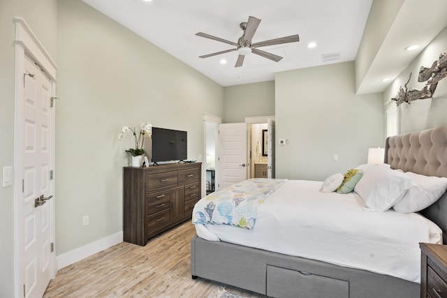 bedroom with light wood-type flooring, ensuite bathroom, and ceiling fan