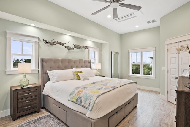 bedroom with light hardwood / wood-style floors and ceiling fan