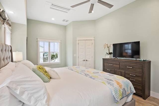 bedroom featuring ceiling fan, light hardwood / wood-style floors, and a closet