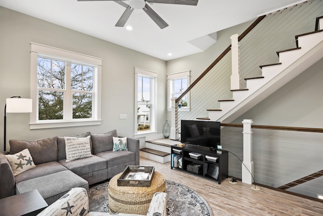 living room featuring hardwood / wood-style flooring and ceiling fan