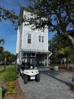 12 Abbie Rd, Santa Rosa Beach, FL 32459 - view of front of property featuring a porch, asphalt driveway, and a chimney
