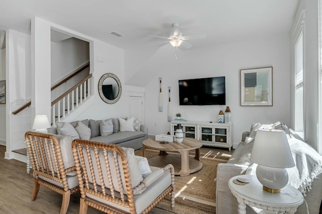 living room featuring hardwood / wood-style floors and ceiling fan