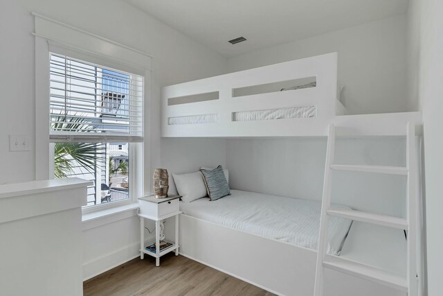 bedroom featuring hardwood / wood-style floors and multiple windows