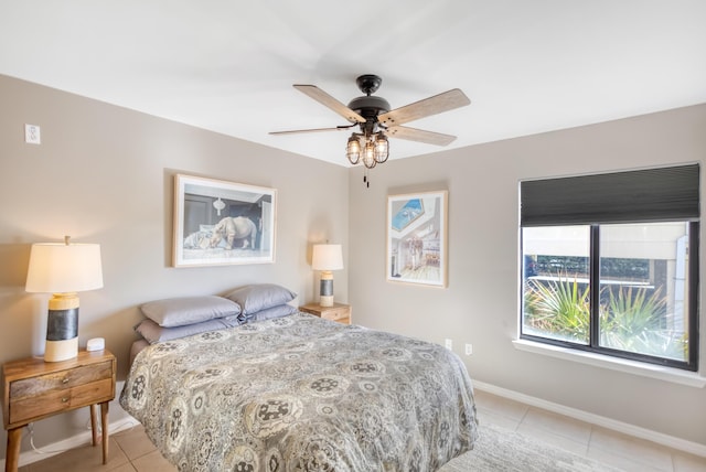 tiled bedroom featuring ceiling fan