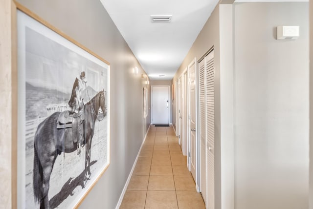 corridor featuring light tile patterned flooring