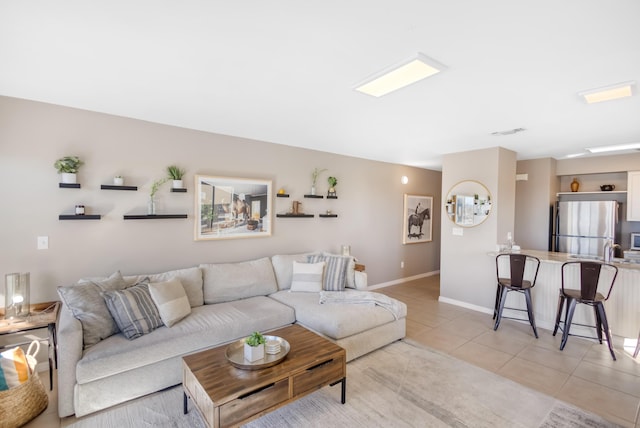 living room with sink and light tile patterned floors