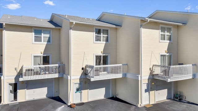 rear view of property with a garage