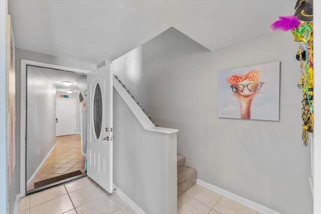 stairway with tile patterned flooring