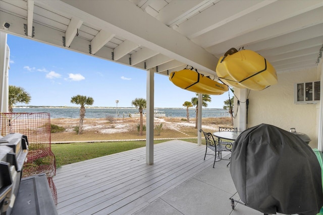 deck featuring a view of the beach, a water view, and grilling area