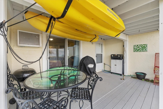 wooden deck with a wall mounted AC