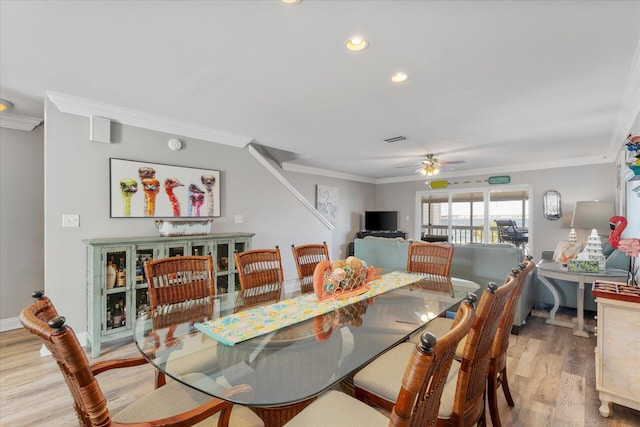 dining room featuring ceiling fan, light hardwood / wood-style floors, and ornamental molding