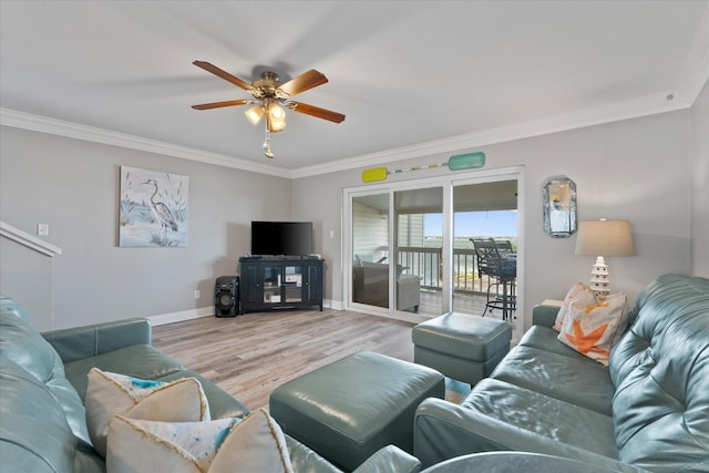 living room with light hardwood / wood-style floors, ceiling fan, and crown molding