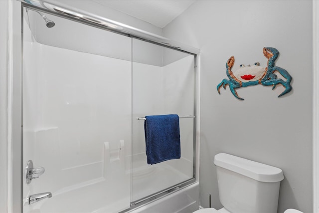 bathroom with enclosed tub / shower combo and toilet