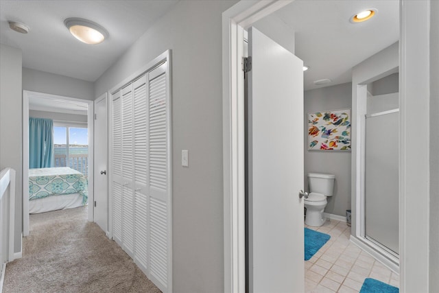 hallway featuring light colored carpet