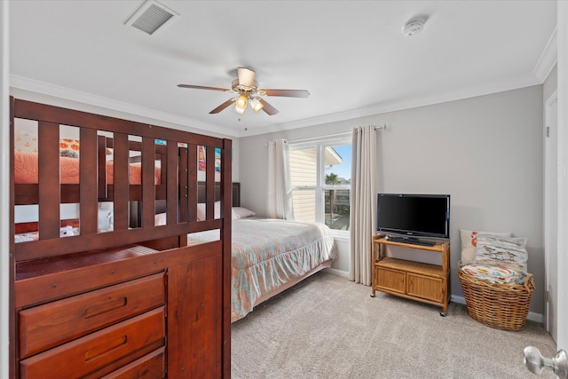 carpeted bedroom with ceiling fan and ornamental molding