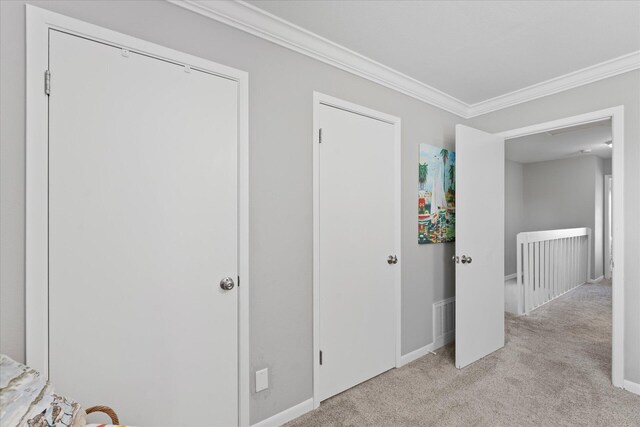 bedroom with light carpet and ornamental molding