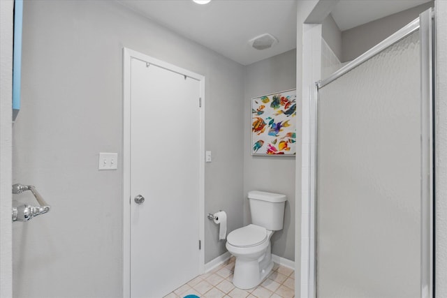 bathroom featuring tile patterned floors, toilet, and walk in shower