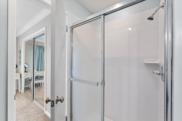 bathroom with crown molding and a shower with door