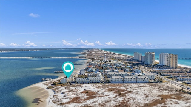 birds eye view of property featuring a water view and a beach view