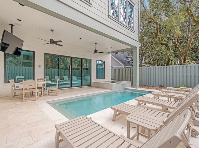 view of pool featuring a patio area, a pool with connected hot tub, ceiling fan, and a fenced backyard