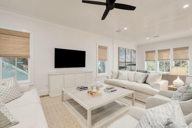 living room with ceiling fan, baseboards, ornamental molding, and recessed lighting