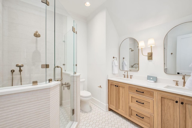 full bath with a sink, double vanity, and a shower stall